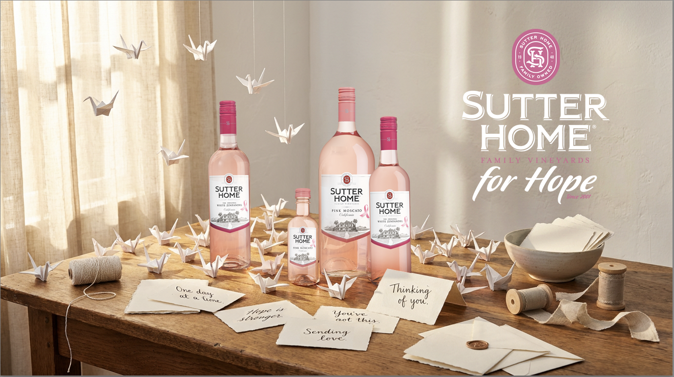Sutter Home bottles of Pink Moscato and White Zinfandel in mini bottles and regular sized bottles, sitting on a wooden table top, with invitation cards and paper cranes 